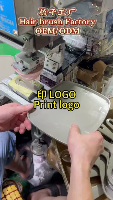 Inside our factory: pad printing logos onto combs and mirrors — the same branding line used for barrettes.