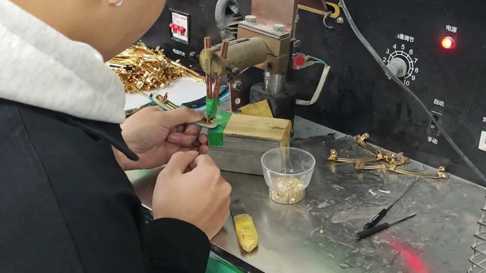 Fixing decoration to a spring metal base