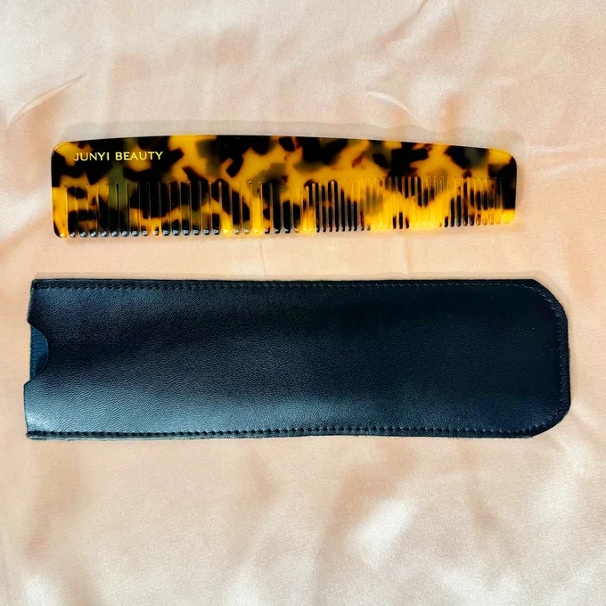 Acetate dressing comb with black leather sleeve