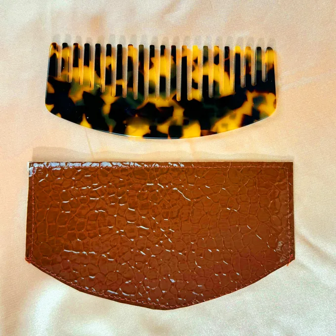 Tortoiseshell acetate dual-tooth comb with its leather sleeve