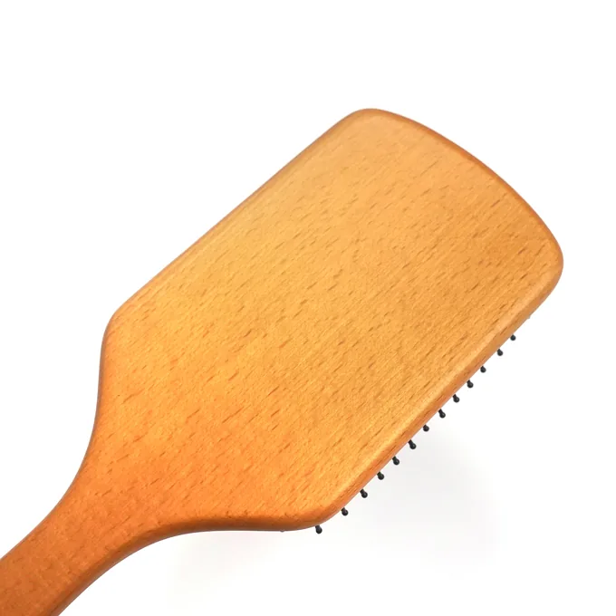 Amber colour-sprayed beechwood paddle showing the smooth painted finish