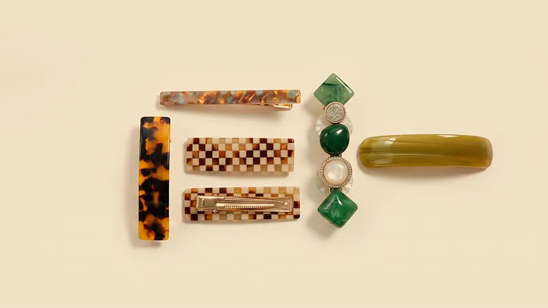 Tortoiseshell cellulose acetate hair barrette with a hinged spring bar