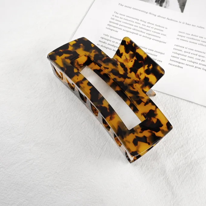 Rectangular frame acetate claw clip with structural cut-out in tortoiseshell