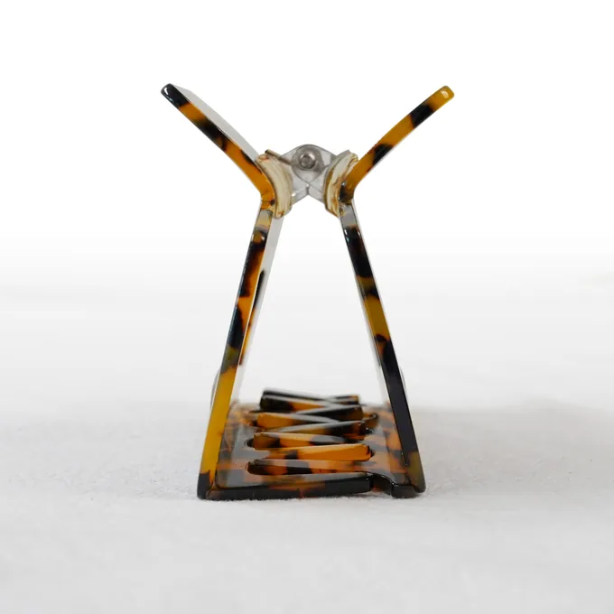 Open rectangular frame claw clip showing the spring and hardware