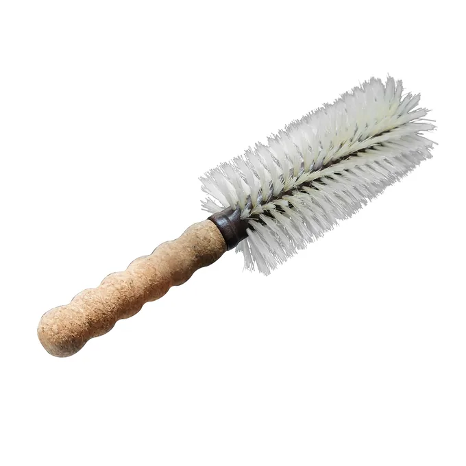 Round blow-dry brush resting on its cork handle, showing the natural cork grip