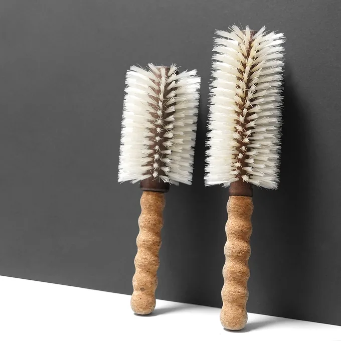 Two sizes of the cork-handle round blow-dry brush shown side by side