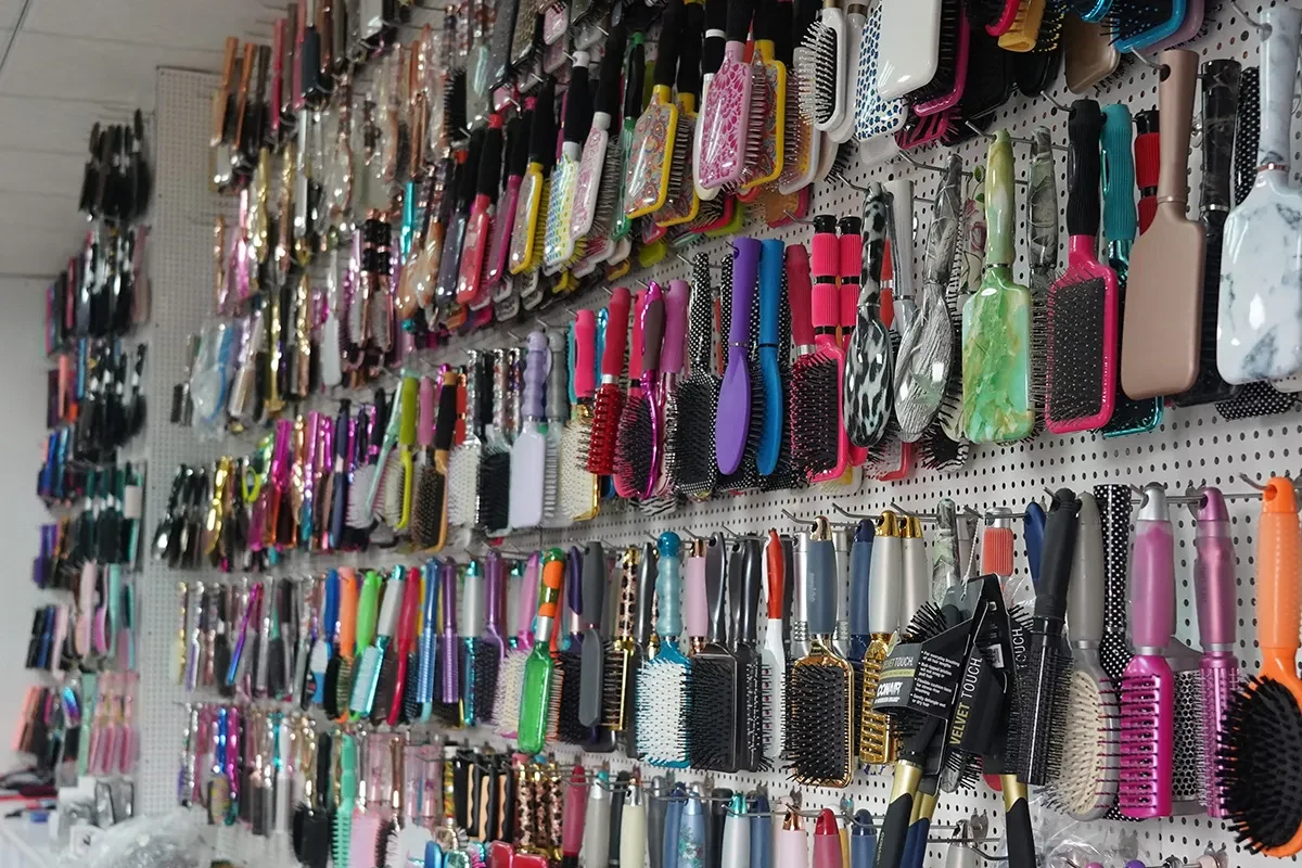 Showroom displaying hair brush, comb and clip samples across materials