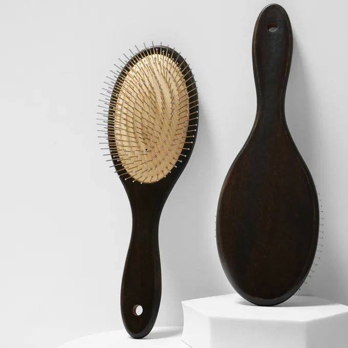 Dark schima wood oval cushion brush, face and back, sprayed finish with visible grain