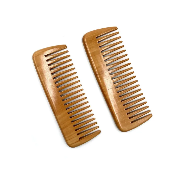 Wooden pocket comb pair combining fine-tooth and wide-tooth halves in one body