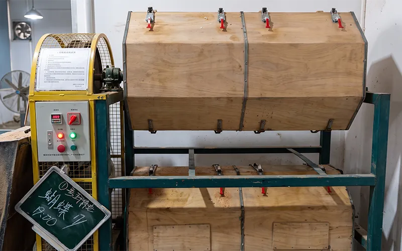 Wooden barrel tumbling machine used to polish acetate parts