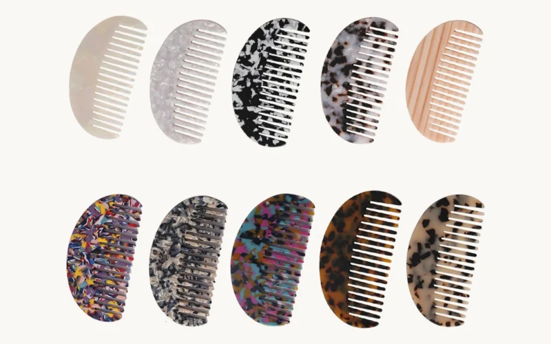 Ten wide-tooth cellulose acetate combs of the same shape in ten different sheet patterns