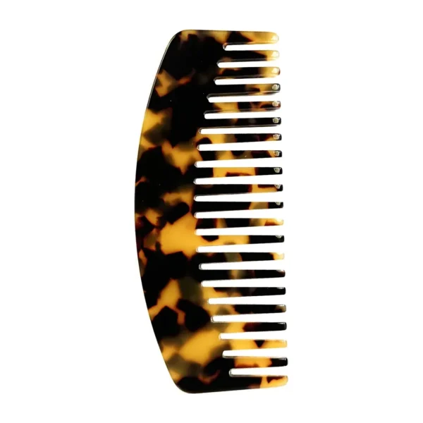 Tortoiseshell cellulose acetate curved comb standing upright on a white background, showing the curved spine and the two tooth densities along the row