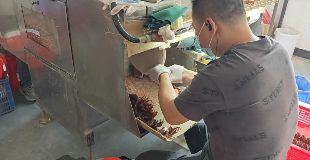 Hand polishing a tortoiseshell acetate piece in white gloves