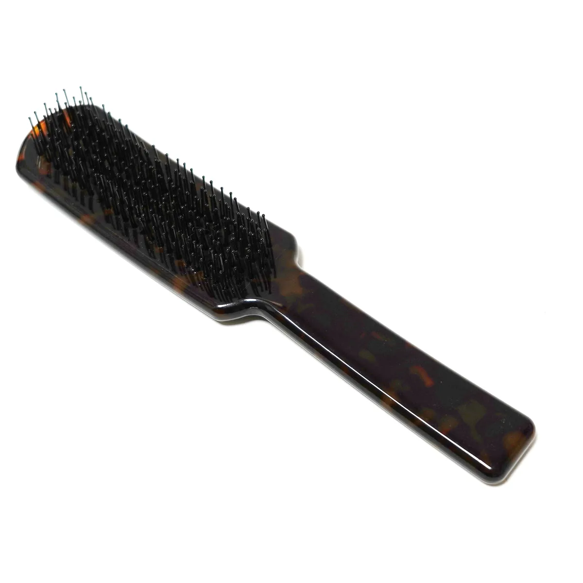 Tortoiseshell acetate paddle brush, angled view of the pin field