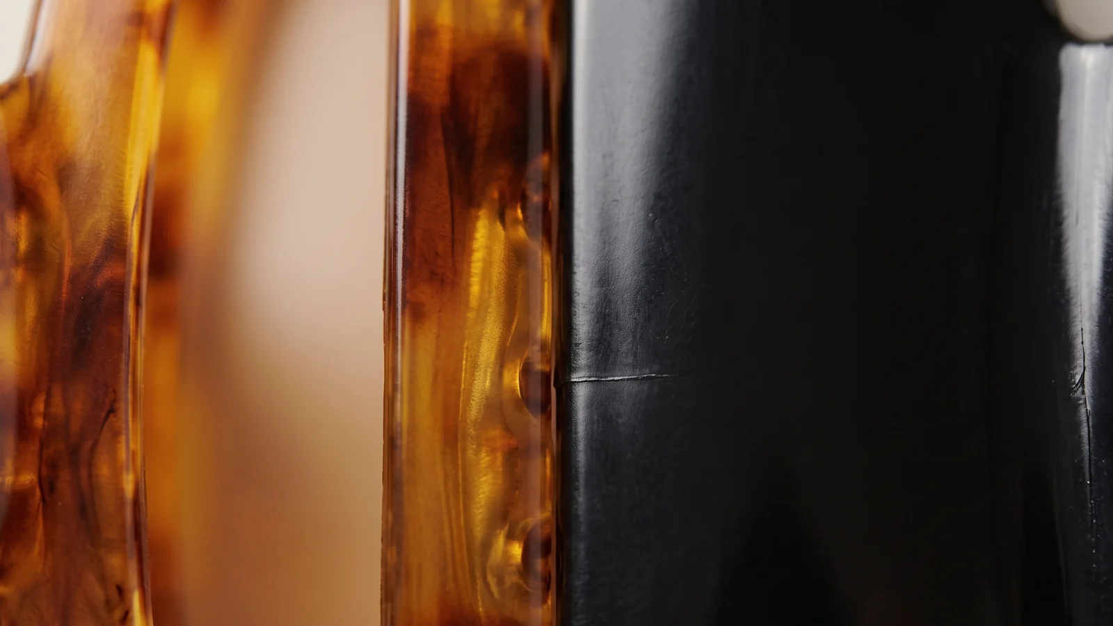 Close-up comparison of translucent cellulose acetate surface next to flat opaque plastic