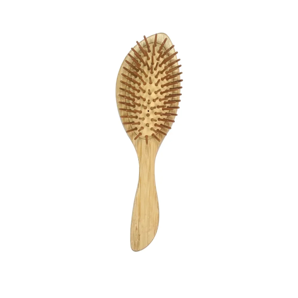 Bamboo cushion hair brush standing upright, showing the full oval field of turned wooden pins on the natural rubber cushion above a shaped bamboo handle