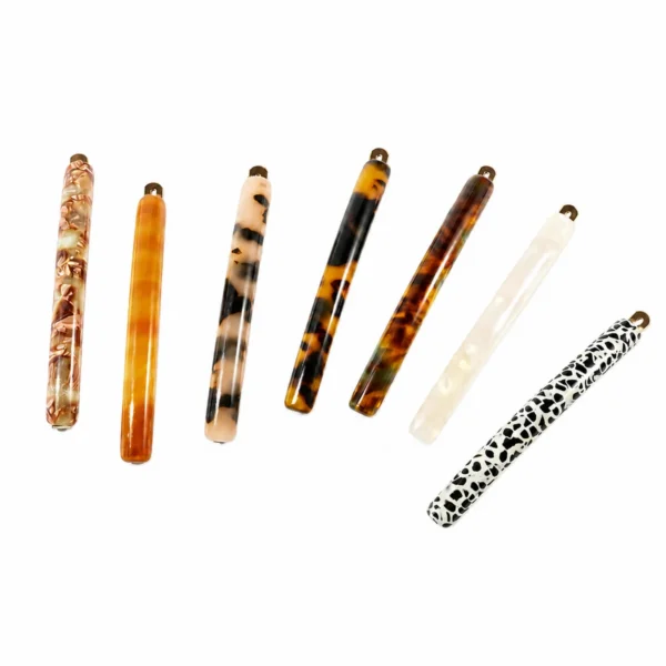 Seven 9cm acetate bar barrettes side by side, full colour range