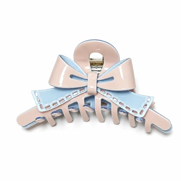 Layered acetate bow claw clip in pastel pink and blue on a white background, showing the sculpted bow over the clip body