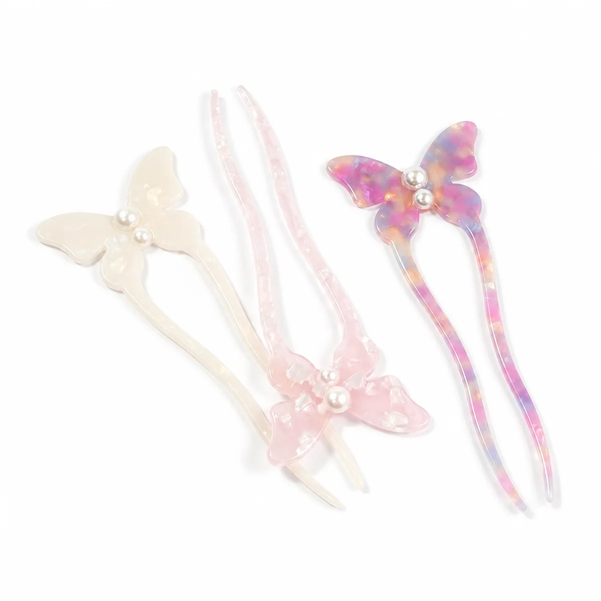 Three butterfly hair forks overlapping across the colour range