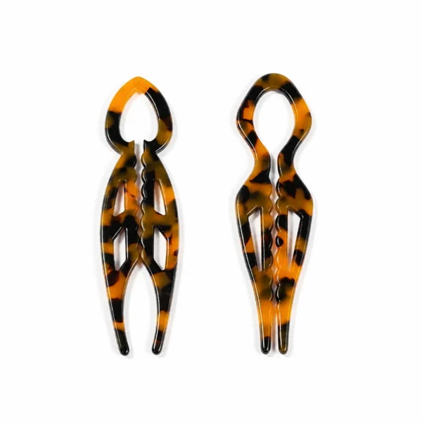 Two carved openwork tortoiseshell hair forks upright, narrow and wide loop heads