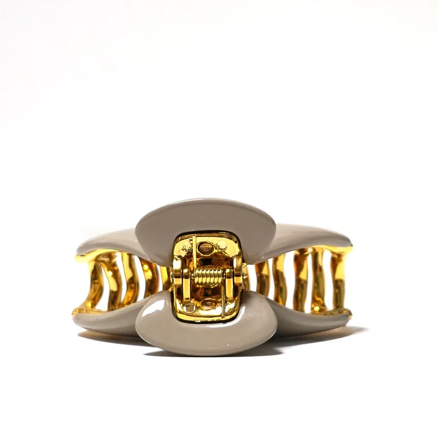 Cream petal claw clip with a gold-plated metal hinge plate