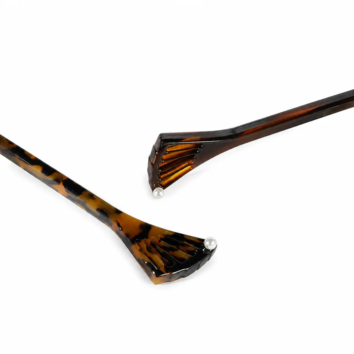 Close-up of the pleated fan head on a tortoiseshell fishtail hair stick