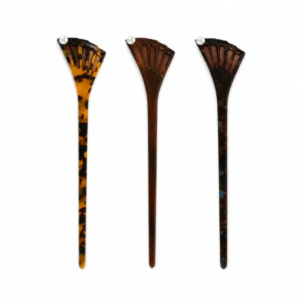 Three fishtail acetate hair sticks upright side by side, fan heads up