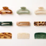 Range of acetate hair accessories including claw clips, barrettes and combs laid out for sourcing