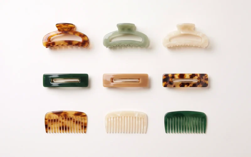 Range of acetate hair accessories including claw clips, barrettes and combs laid out for sourcing