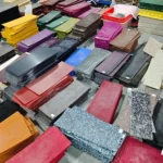Stacks of cellulose acetate sheet in dozens of patterns and colours stored on a hair accessory factory floor