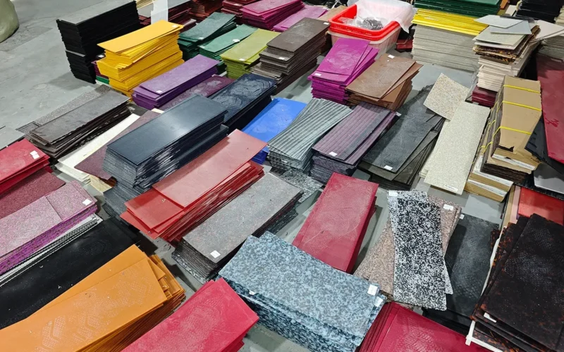 Stacks of cellulose acetate sheet in dozens of patterns and colours stored on a hair accessory factory floor