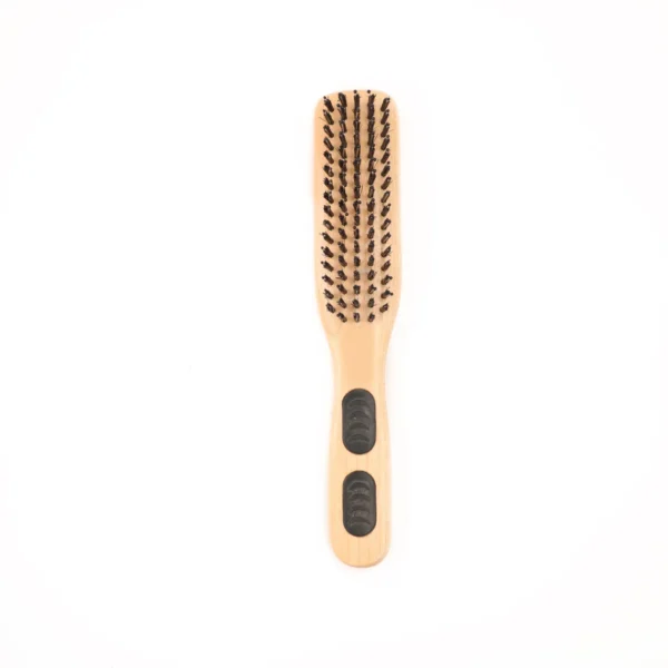 Slim styling brush standing upright with the bristle head at the top, showing rows of boar and nylon bristles above a beech handle with two moulded rubber grip inserts