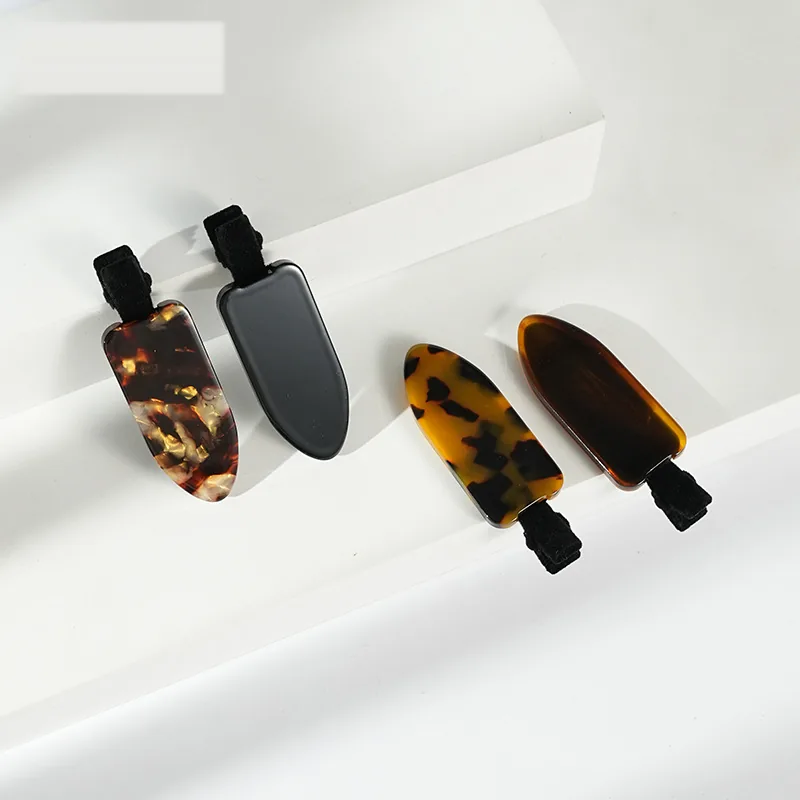 Four acetate side clip colourways on a white step background