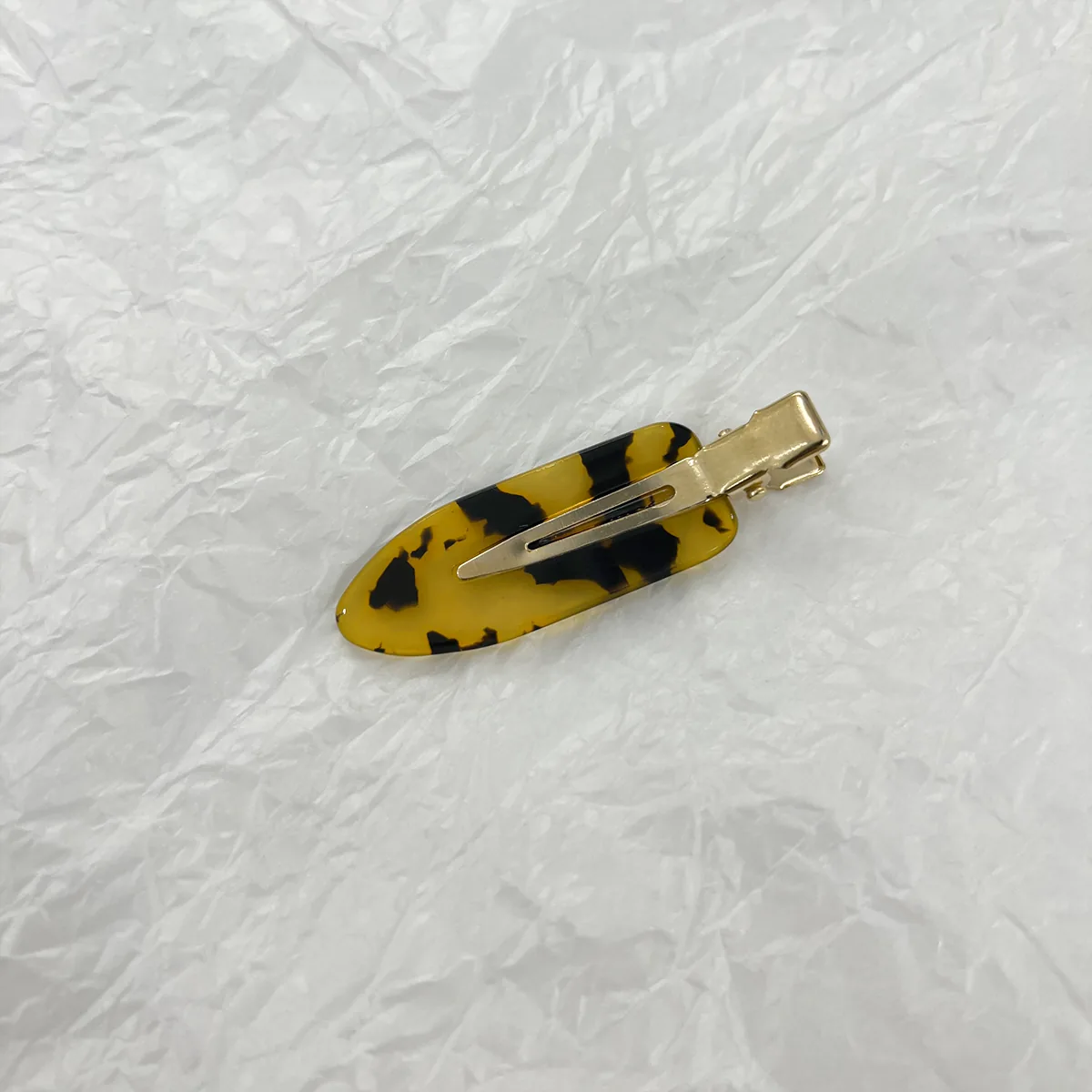 Yellow tortoiseshell acetate duckbill clip with gold alligator base