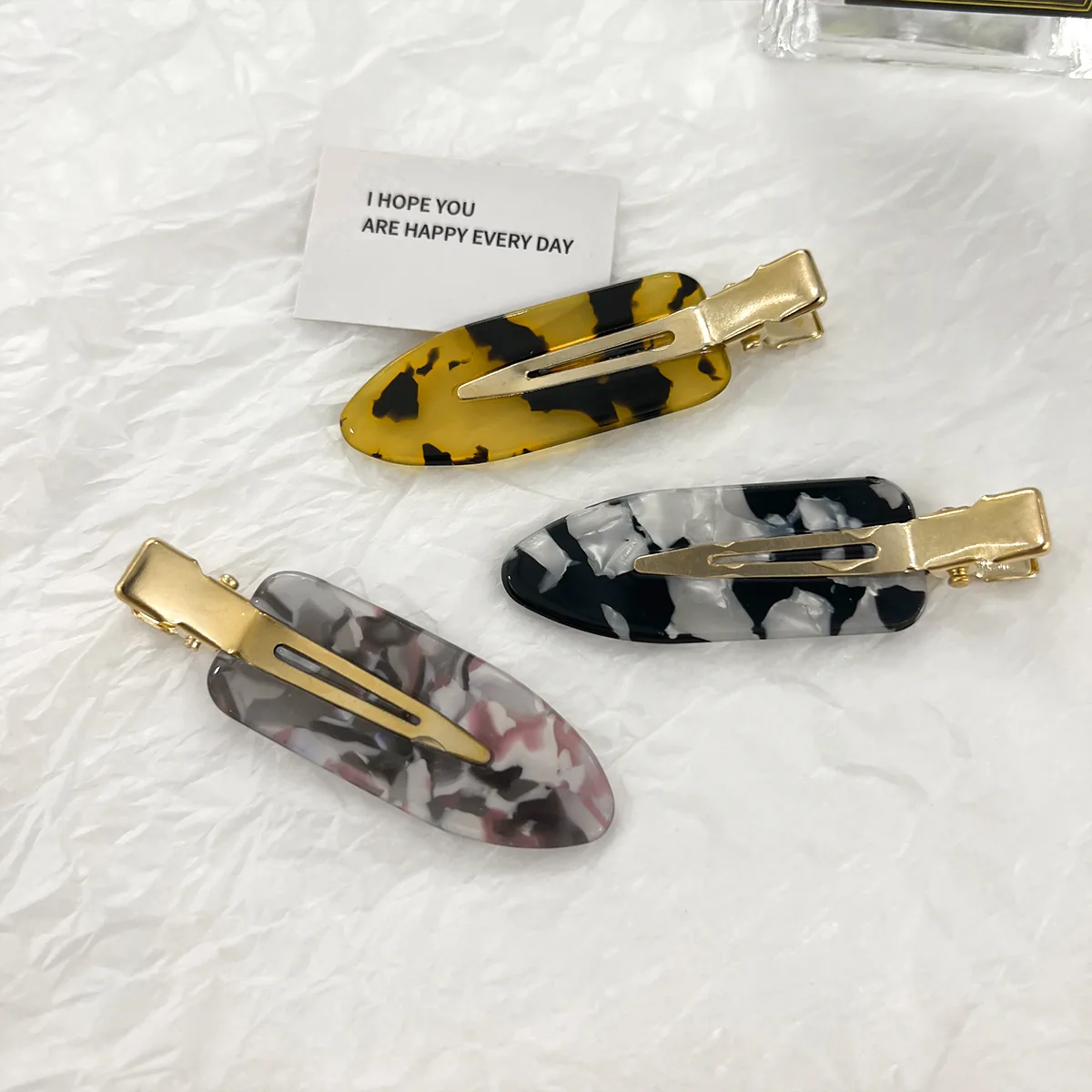 Yellow, grey-pink and monochrome tortoiseshell duckbill clips
