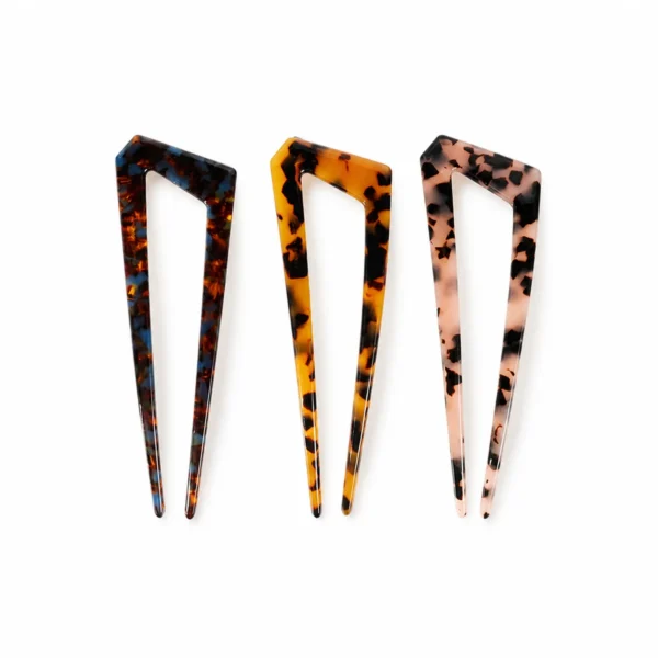 Three two-prong acetate hair forks upright side by side, full V profile visible