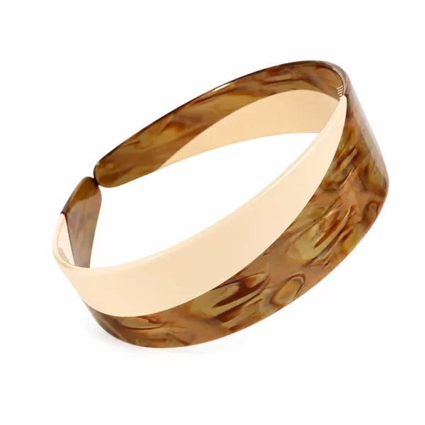 Two-tone acetate headband on a white background, showing the amber and cream colour block running through the laminated band