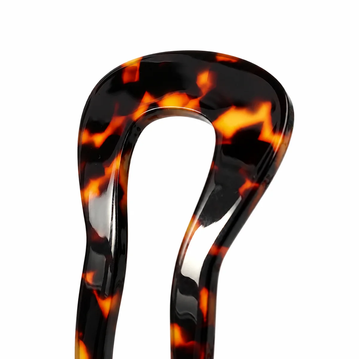 Close-up of the rounded head on a tortoiseshell wavy-prong hair fork
