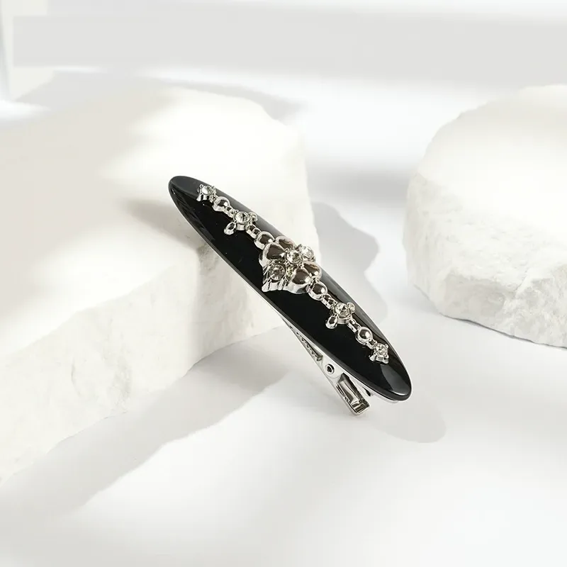Black willow-leaf acetate barrette with silver crystal motif