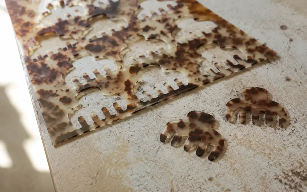 Claw clip blanks cut from tortoiseshell cellulose acetate sheet
