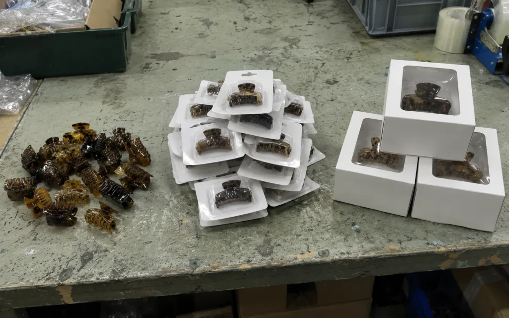 The same claw clips loose, blister carded and boxed, showing how much more space packaging takes up