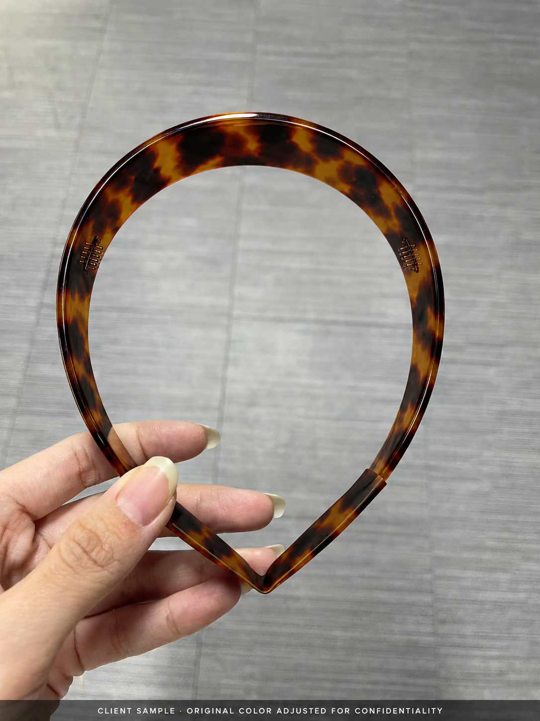 Anonymised wide headband sample showing left and right segmented teeth with tortoiseshell colour adjusted for confidentiality