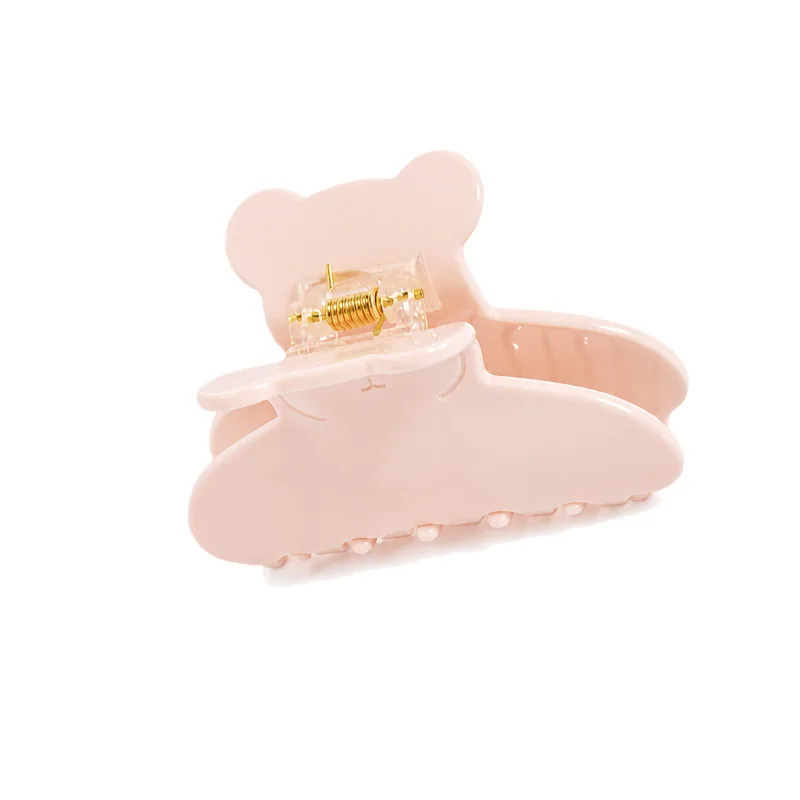 Blush pink acetate claw clip with a bear-shaped upper arm