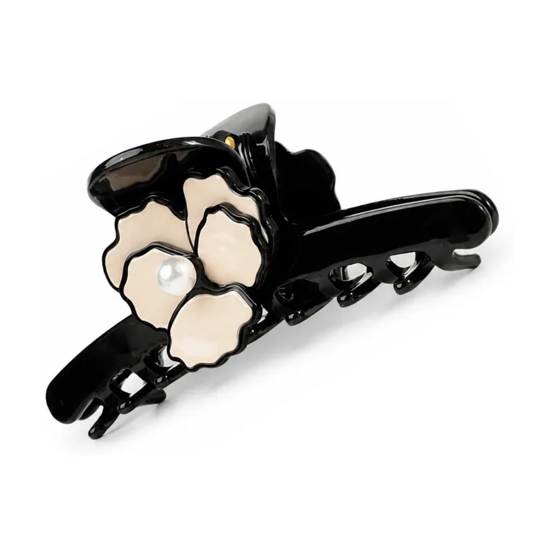 Gloss black acetate claw clip with a carved ivory camellia and pearl centre