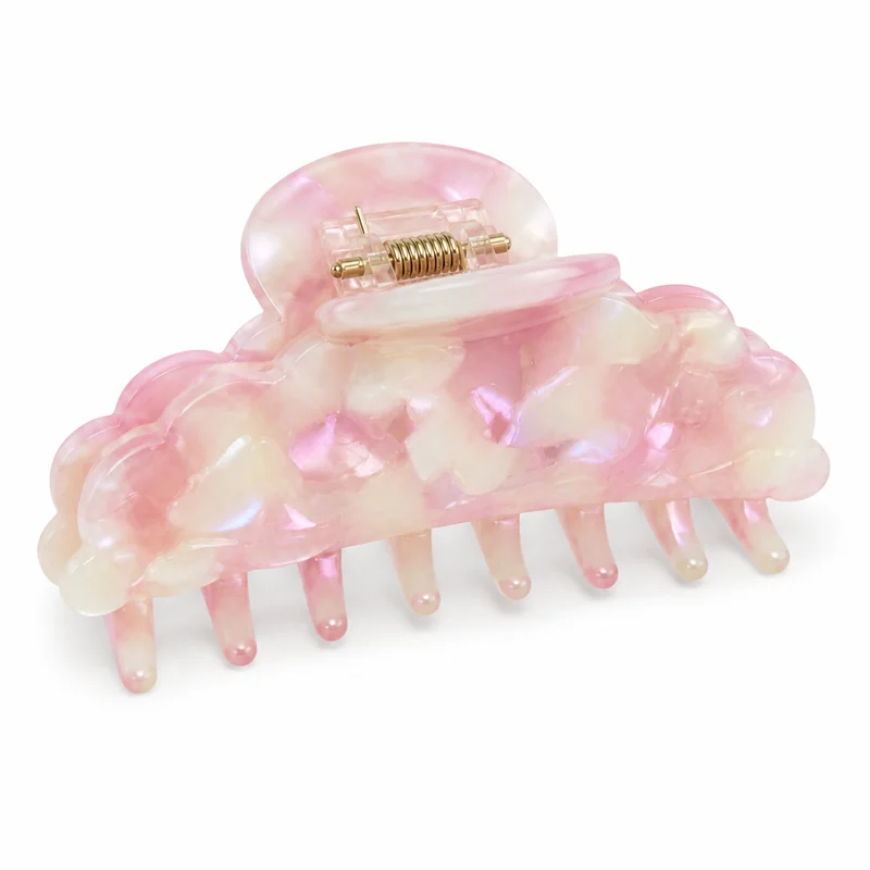Pink opal acetate claw clip with a carved pebble surface