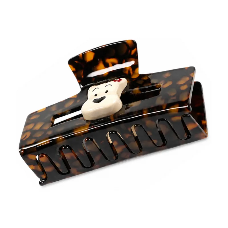 Tortoiseshell acetate rectangular frame claw clip with an ivory puppy inlay