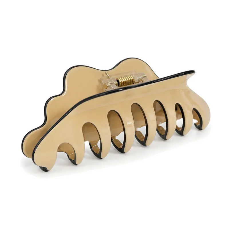 Ivory acetate claw clip with a scalloped silhouette and black edge trim